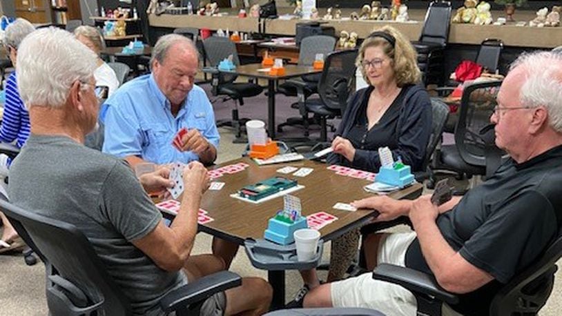 Members of the Miami Valley Bridge Association concentrate on their cards but take breaks to chat and enjoy snacks between hands. CONTRIBUTED