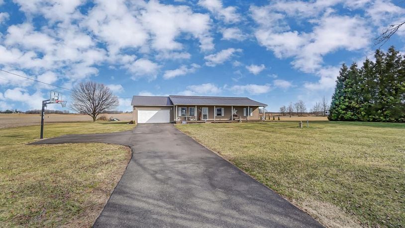 The front of the custom-built ranch home has a long newly paved driveway, basketball hoop, full wood front porch and attached two-car garage. Contributed photos