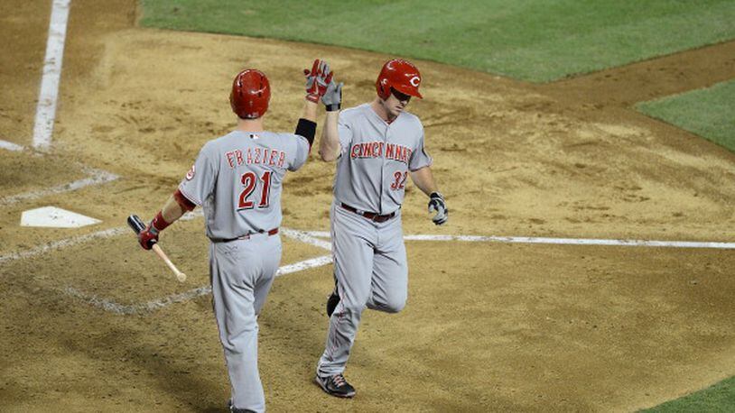 PHOENIX, AZ - JUNE 21: Jay Bruce #32 of the Cincinnati Reds is greeted at home plate by teammate Todd Frazier #21 after hitting a home run against the Arizona Diamondbacks at Chase Field on June 21, 2013 in Phoenix, Arizona. (Photo by Norm Hall/Getty Images)