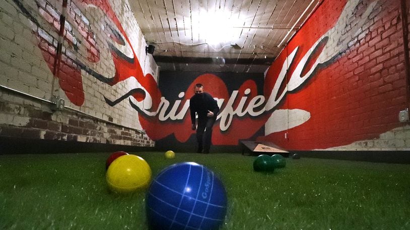 Patrick Williams, the owner of COhatch, plays on the new full length bocce ball and corn hole court in the basement of COhatch. The new activity area is not open due to COVID restrictions and social distancing but will be open as soon as the restrictions are lifted. BILL LACKEY/STAFF