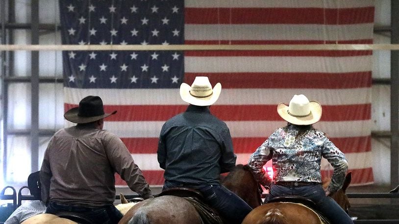 Three competitors in the team ranch sorting competition at the Champions Expo Center in Clark County wait their turn to race against the clock and sort designated calves from the herd. BILL LACKEY/STAFF