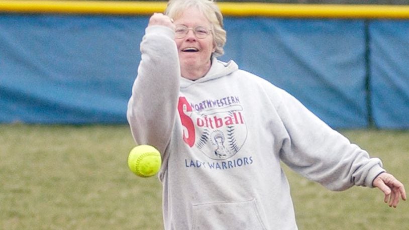 Northwestern legend Nancy Dutton throws the first pitch of Northwestern's softball season opener against Greeneview in 2006. News-Sun file photo