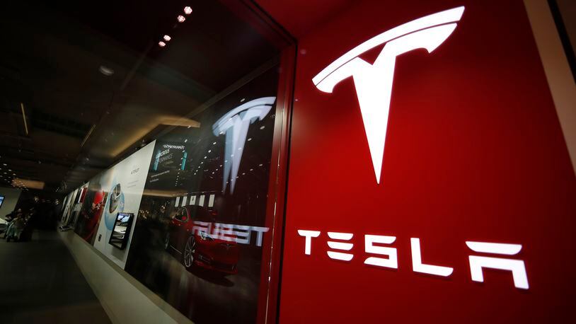 FILE - The Tesla logo is displayed at the company's store in Cherry Creek Mall, Feb. 9, 2019, in Denver. Tesla's stock tumbled below $150 per share Thursday, April 18, 2024, giving up all of the gains made over the past year as the electric vehicle maker reels from falling sales and steep discounts intended to lure more buyers. (AP Photo/David Zalubowski, File)
