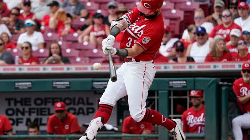 Cincinnati Reds' Jesse Winker hits a single during the first inning of a baseball game against the Pittsburgh Pirates in Cincinnati, Sunday, Aug. 8, 2021. (AP Photo/Jeff Dean)