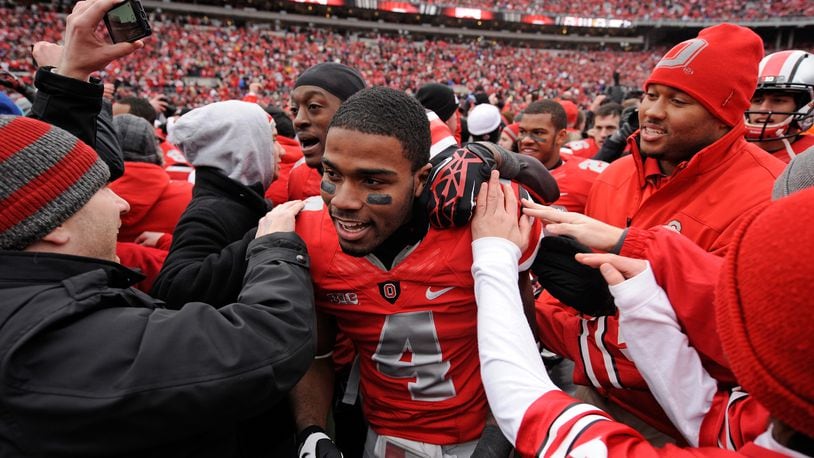 C.J. Barnett #4 of the Ohio State Buckeyes is congratulated by fans after Ohio State defeated the Michigan Wolverines 26-21 at Ohio Stadium on November 24, 2012 in Columbus.