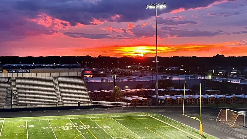 The sun sets as Springfield and Saint Ignatius wait out a lightning delay on Saturday, Aug. 20, 2022, at Byers Field in Parma. The game was cancelled. David Jablonski/Staff