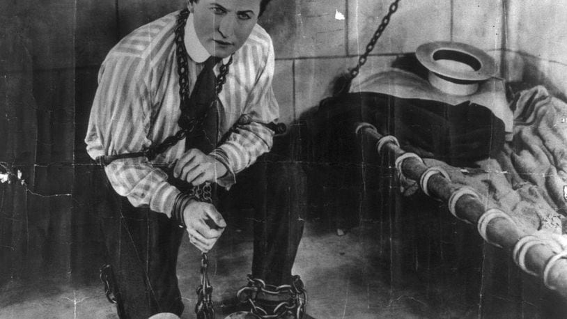 A photo of escape artist Harry Houdini circa 1898. For Houdini (1874–1926), stone walls and chains do not make a prison.