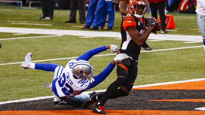 Cincinnati Bengals wide receiver A.J. Green (18) makes a catch for a touchdown over Dallas Cowboys cornerback Saivon Smith (32) in the first half of an NFL football game in Cincinnati, Sunday, Dec. 13, 2020. (AP Photo/Aaron Doster)