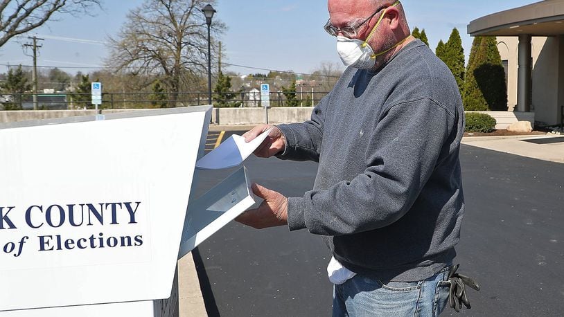 William Griffith places his absentee ballots in the dropbox in front of the Clark County Board of Elections at Springfield Government Center Wednesday. BILL LACKEY/STAFF