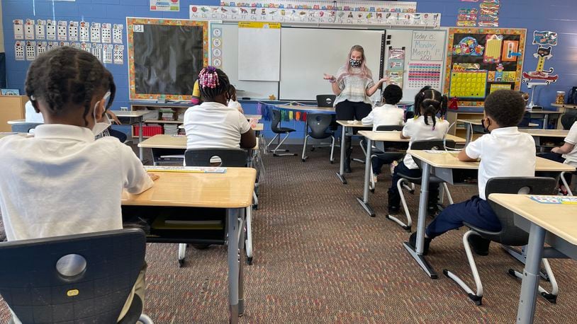 A Fairview Elementary teacher welcomes students back to school and reviews COVID-19 protocols with them before beginning class on March 1. Approximately 75% of Dayton Public Schools students returned for in-person instruction in March, with the rest choosing to stay online. CONTRIBUTED PHOTO