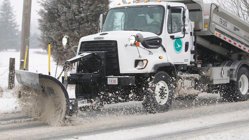 An ODOT truck plows and salts U.S. 68 south of Xenia after another winter storm blew through the area early Wednesday morning.   TY GREENLEES / STAFF