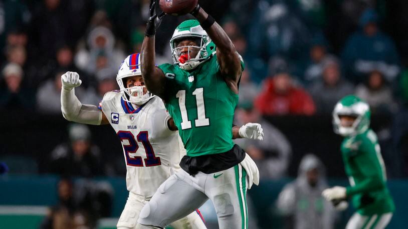 FILE - Philadelphia Eagles wide receiver A.J. Brown (11) makes a catch as Buffalo Bills safety Jordan Poyer (21) defends during an NFL football game Nov. 26, 2023, in Philadelphia. The Eagles and Brown have agreed to a three-year contract extension. (AP Photo/Rich Schultz, File)