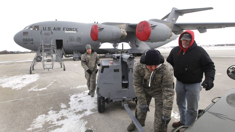 Airmen repair a fuel boost pump on a 445th Airlift Wing C-17 cargo jet at Wright-Patterson Air Force Base in this 2013 file photo. The Air Force has said it has reduced a shortage of aircraft maintainers. LISA POWELL/STAFF