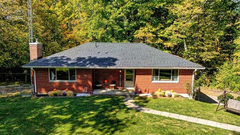 The 3-bedroom, brick ranch offers about 1,360 sq. ft. of living space with a partially finished, walk-out basement. The home is set on almost 6 acres that are wooded and has a creek. CONTRIBUTED PHOTO