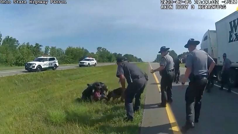 FILE - This image taken from Ohio State Highway Patrol body camera video shows a police dog attacking Jadarrius Rose, 23, of Memphis, Tenn., on July 4, 2023, in Circleville, Ohio. The central Ohio city agreed Thursday, Feb. 8, 2024, to a settlement with a former K-9 officer and truck driver involved in an attack last year in which video from the event garnered national attention and raised questions about the use of canines in apprehending suspects. (Ohio State Highway Patrol via AP, File)