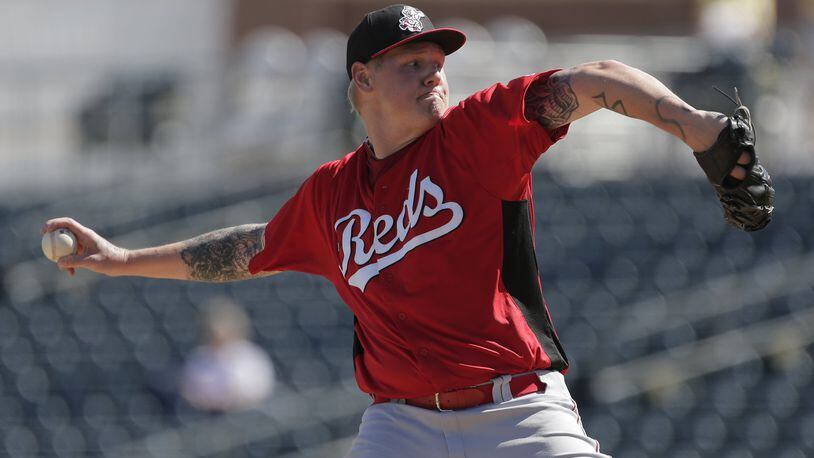 Cincinnati Reds starting pitcher Mat Latos throws during an exhibition spring training baseball game against the Kansas City Royals Friday, March 1, 2013, in Surprise, Ariz. (AP Photo/Charlie Riedel)