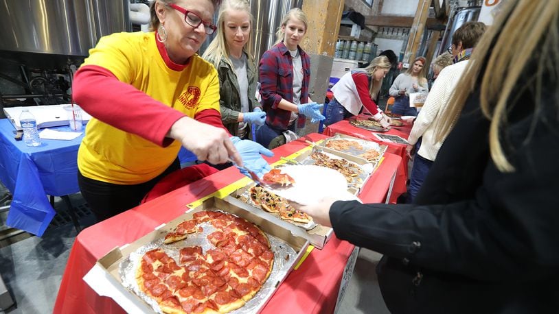 Hundreds of people showed up for the annual Slice of Springfield fundraiser at Mother Stewart's Brewery to sample pizza from eight area pizza shops and vote for their favorite in this file image. The event raises money to help support National Trail Parks and Recreation. BILL LACKEY/STAFF