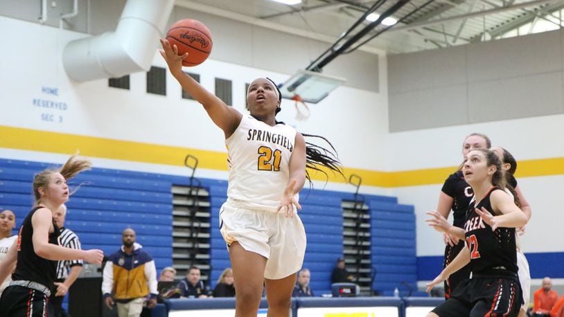 Springfield's Destiny Wells puts up a shot during a game against Beavercreek last season. The Wildcats are dedicating the season to Wells, who died in a car accident in August. Michael Cooper/CONTRIBUTED