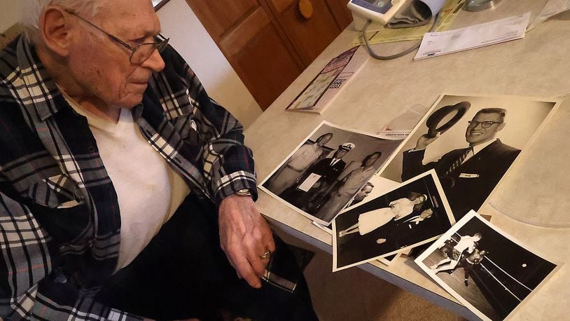 Gene Zeigler looks over some of the photos from his extraordinary life Wednesday, April 6, 2022. BILL LACKEY/STAFF