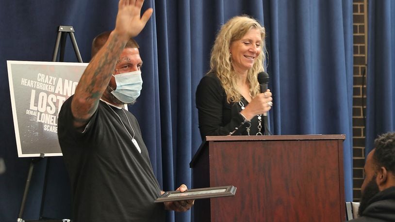 Doug, a graduate of the Clark County Family Treatment Court, waves to the crowd of supporters as he receives his certificate Tuesday, May 25, 2022. BILL LACKEY/STAFF