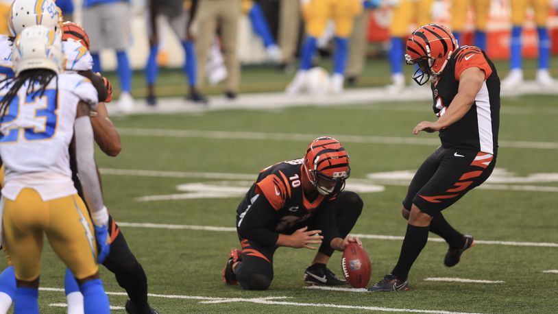 Cincinnati Bengals kicker Randy Bullock (4) misses a field goal out of the hold of Kevin Huber (10) during the second half of an NFL football game against the Los Angeles Chargers, Sunday, Sept. 13, 2020, in Cincinnati. The field goal would have tied the game. Los Angeles Chargers won 16-13. (AP Photo/Aaron Doster)