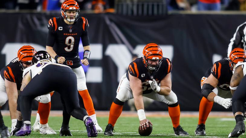 Bengals center Ted Karras gets ready to hike the ball to quarterback Joe Burrow during Cincinnati's AFC Wild Card playoff game against the Baltimore Ravens Sunday, Jan. 15, 2023 at Paycor Stadium in Cincinnati. The Bengals won 24-17. NICK GRAHAM/STAFF