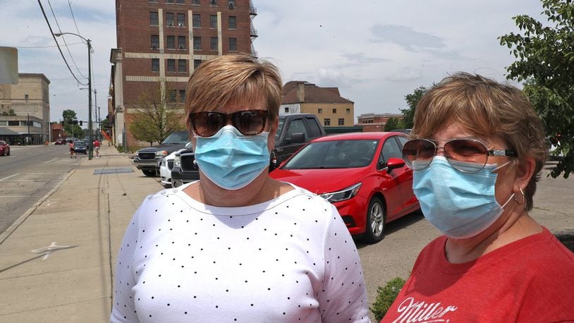 Tracy Wickham, left, and Denise See, who both work at United Senior Services, were wearing their masks as they took a walk around downtown Springfield Friday. BILL LACKEY/STAFF