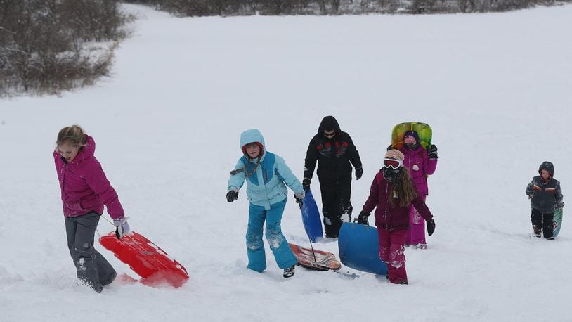 Sledders at Reid Park on day off from school this winter because of snow. BILL LACKEY/STAFF
