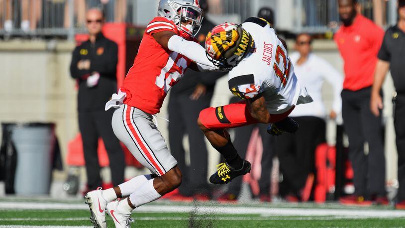 COLUMBUS, OH - OCTOBER 7:  Denzel Ward #12 of the Ohio State Buckeyes hits Taivon Jacobs #12 of the Maryland Terrapins after a reception in the first quarter at Ohio Stadium on October 7, 2017 in Columbus, Ohio. Ward was ejected from the game after being assessed a targeting penalty for the hit.  (Photo by Jamie Sabau/Getty Images)