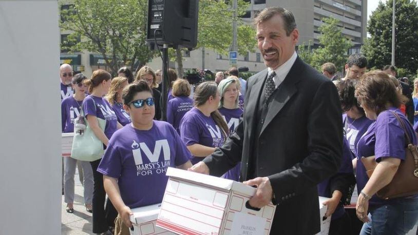 Marsy’s Law founder Henry Nicholas and other supporters of the proposed victims’ right constitutional amendment help carry boxes of petitions into the secretary of state’s office. Marc Kovac/ Gatehouse Media