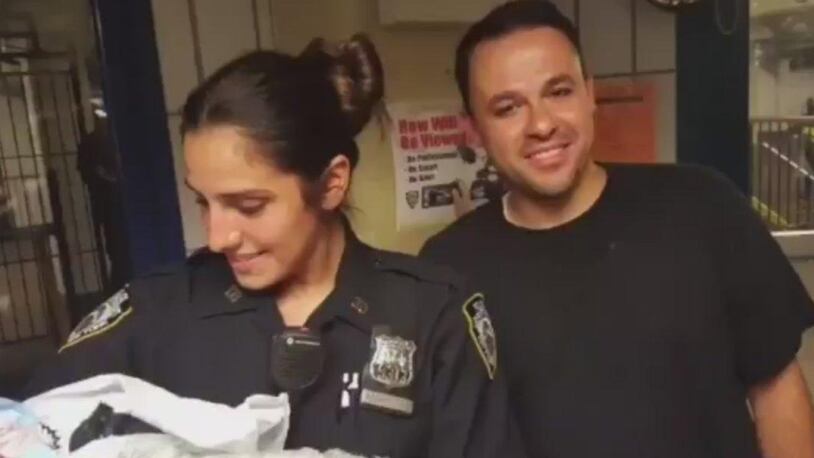 NYPD transit officers Ana Martinez and Stephen Geniale with the baby they helped deliver in Brooklyn.