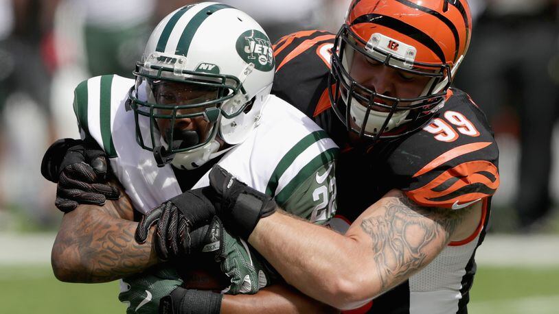EAST RUTHERFORD, NJ - SEPTEMBER 11: Margus Hunt #99 of the Cincinnati Bengals tackles Matt Forte #22 of the New York Jets during their game at MetLife Stadium on September 11, 2016 in East Rutherford, New Jersey. (Photo by Streeter Lecka/Getty Images)