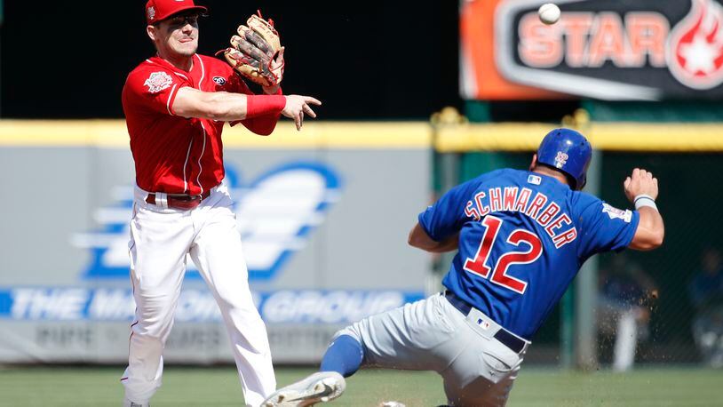 CINCINNATI, OH - JUNE 29: Scooter Gennett #3 of the Cincinnati Reds turns a double play over Kyle Schwarber #12 of the Chicago Cubs in the third inning at Great American Ball Park on June 29, 2019 in Cincinnati, Ohio. (Photo by Joe Robbins/Getty Images)