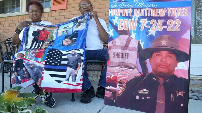 Lisa Yates, the mother of fallen Clark County Sheriff's Deputy Matthew Yates and Otis Williams, his uncle, with some of the momentoes of Matt Tuesday 20, 2022. BILL LACKEY/STAFF