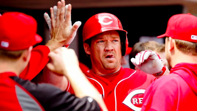 Scott Rolen high-fives his teammates after hitting in a home run in Thursday’s game against the Giants April 26, 2012, at Great American Ball Park in Cincinnati, Ohio. Staff photo by Nick Daggy