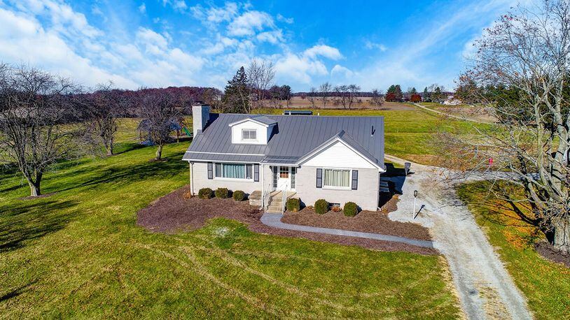 The brick Cape Cod-style home on 10 acres offers about 2,440 sq. ft. of living space with a main bedroom suite and second bedroom on the first level and 2 additional bedrooms upstairs. CONTRIBUTED PHOTO