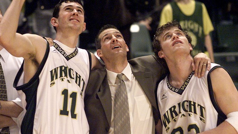Wright State University’s head coach Ed Schilling puts his arms around his two senior players Cain Doliboa, left, and Jesse Deister, right, as they watch highlights from the season after winning their final season game against Loyola University at the Nutter Center on Sunday February 24, 2002.