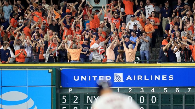 HOUSTON, TX - OCTOBER 21:  Fans cheer as Evan Gattis #11 of the Houston Astros rounds the bases after hitting a a solo home run against CC Sabathia #52 of the New York Yankees during the fourth inning in Game Seven of the American League Championship Series at Minute Maid Park on October 21, 2017 in Houston, Texas.  (Photo by Ronald Martinez/Getty Images)