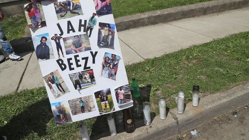 A memorial has started to form at the scene of a fatal mass shooting along Clifton Avenue Monday, May 2, 2022. One woman was killed and four others wounded in a shooting in front of 1227 Clifton Avenue early Sunday morning. BILL LACKEY/STAFF
