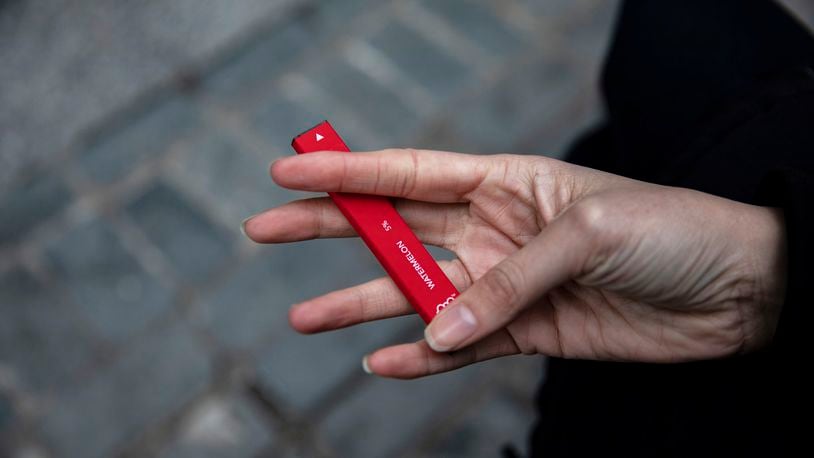FILE - In this Jan. 31, 2020 photo a woman holds a flavored disposable vape device in New York. A government study on adolescent vaping, released on Thursday, Oct. 6, 2022, finds more than 2.5 million U.S. kids were using some form of e-cigarette in 2022, suggesting there’s been little progress in keeping vaping devices out of the hands of teenagers. (AP Photo/Marshall Ritzel, File)