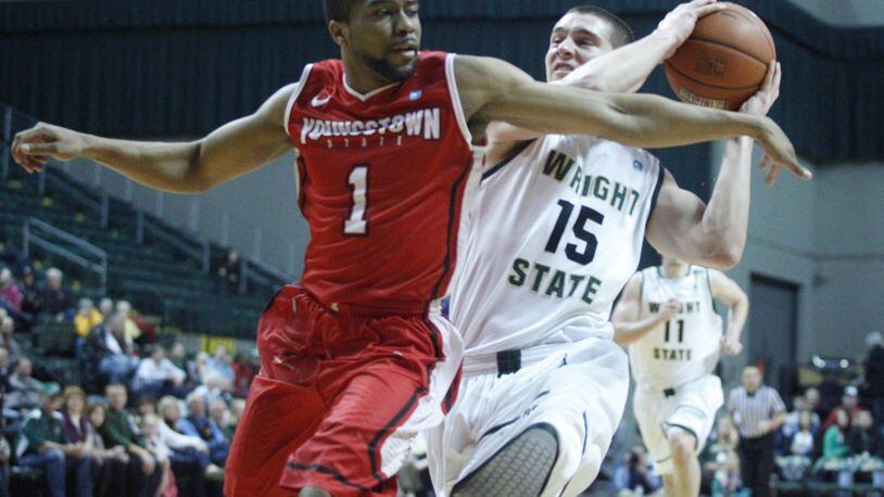 Wright State guard Kendall Griffin, left, drives to the basket in the first half on Saturday at the Nutter Center. David Jablonski/Staff