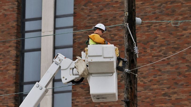 FILE PHOTO: Hamilton city crews work to restore power on Dayton Street after storms with heavy rain and strong winds caused power outages and down trees and limbs around Butler County Monday evening, June 13, 2022. NICK GRAHAM/STAFF