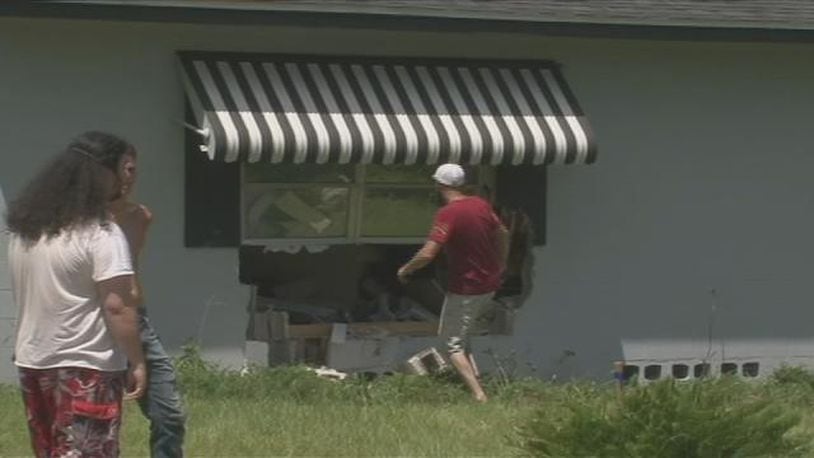 The couch ended up sliding several feet away from where the pickup truck crashed through. (WFTV.com)