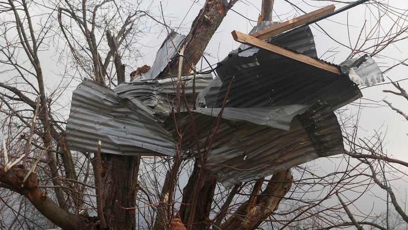 Metal debri wrapped around a tree along Ridge Road after Wednesday's storm. BILL LACKEY/STAFF