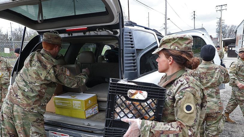Ohio National Guard members based in Springfield helped distributed food during the coronavirus pandemic at the Second Harvest Food Bank as a line of cars, waiting for food, wrapped around the food bank.