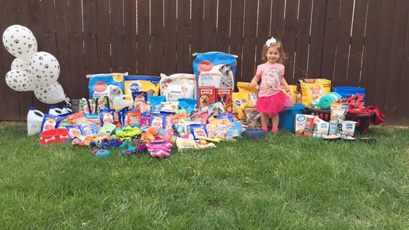 Eloise McKinnon stands next to some of the donations for local animal shelters that were raised at her birthday party. Contributed photo