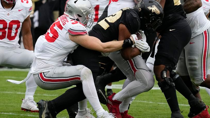 Purdue's Dylan Downing (22) is tackled by Ohio State linebacker Tommy Eichenberg (35) during the first half of an NCAA college football game, Saturday, Oct. 14, 2023, in West Lafayette, Ind. (AP Photo/Darron Cummings)