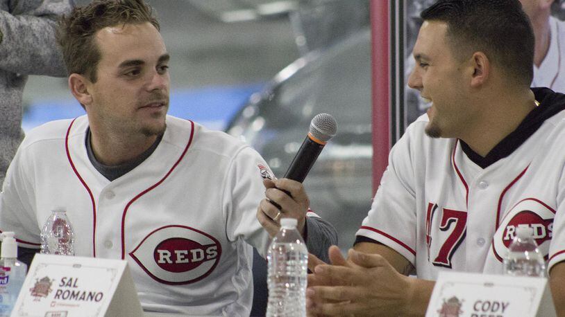 Reds second baseman Scooter Gennett (left) has fun with pitcher Sal Romano during the Q and A session at Saturday’s Reds Caravan stop at the Air Force Museum. Jeff Gilbert/CONTRIBUTED