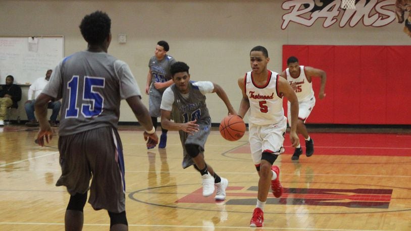 Amir Foster of Trotwood drives against the visiting Xenia defense in a boys basketball game Friday, Dec. 16, 2016. MIKE HARTSOCK / WHIO-TV