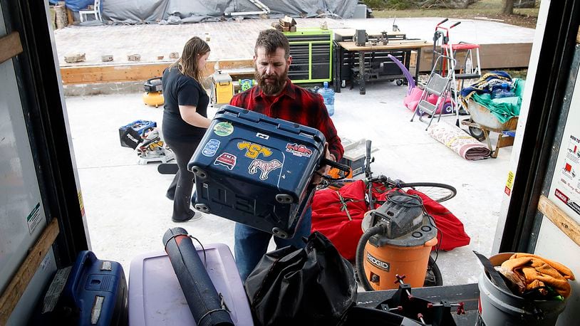 Jon Stewart and his family load the last of their belongings in the back of a U-Haul truck parked where his garage once stood Monday, March 4, 2024. Stewart's house on Mitchell Road was destroyed by the Feb. 28 tornado that hit the area. BILL LACKEY/STAFF